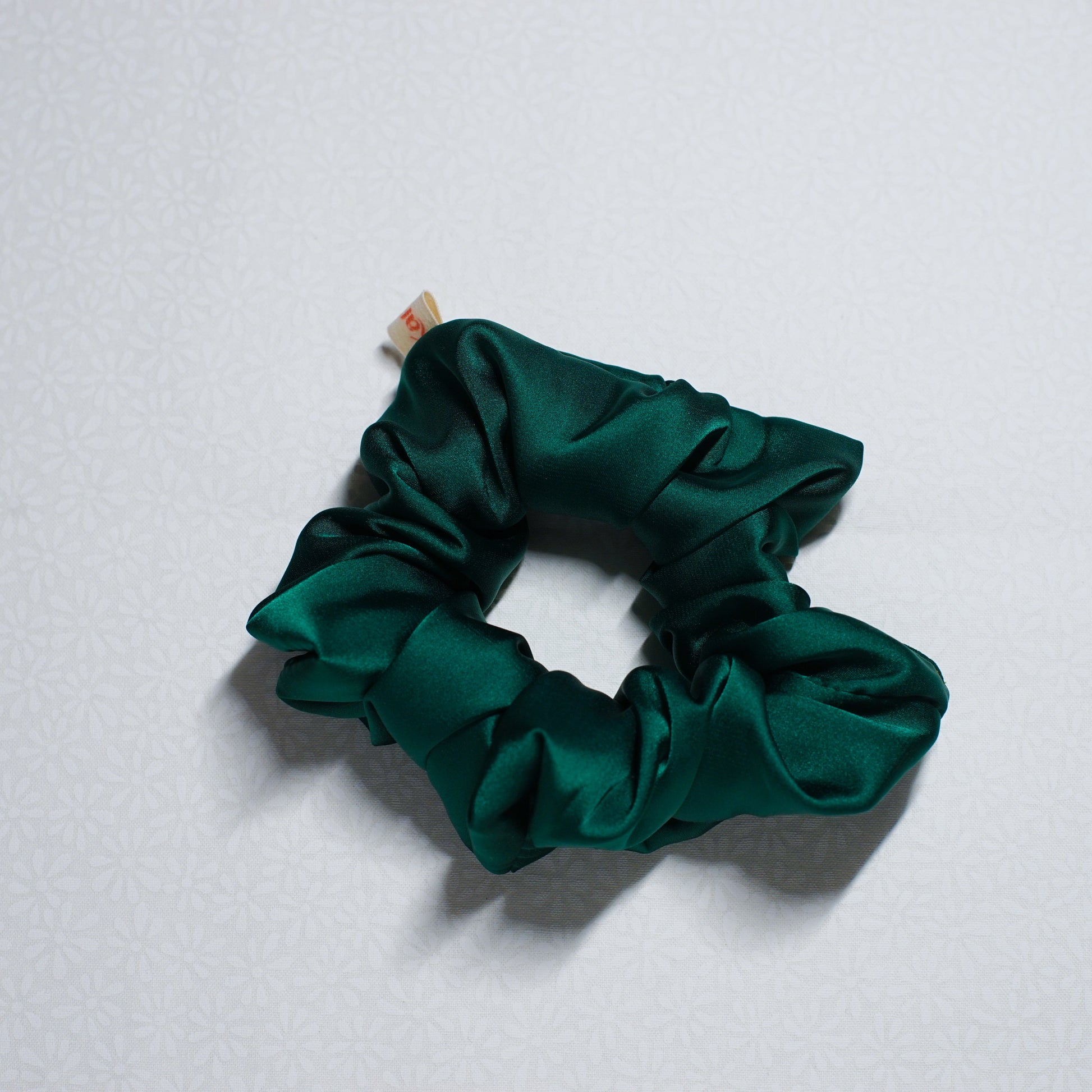 Green scrunchie on a white background